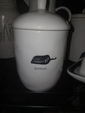Rae Dunn white ceramic jar with black scoop graphic